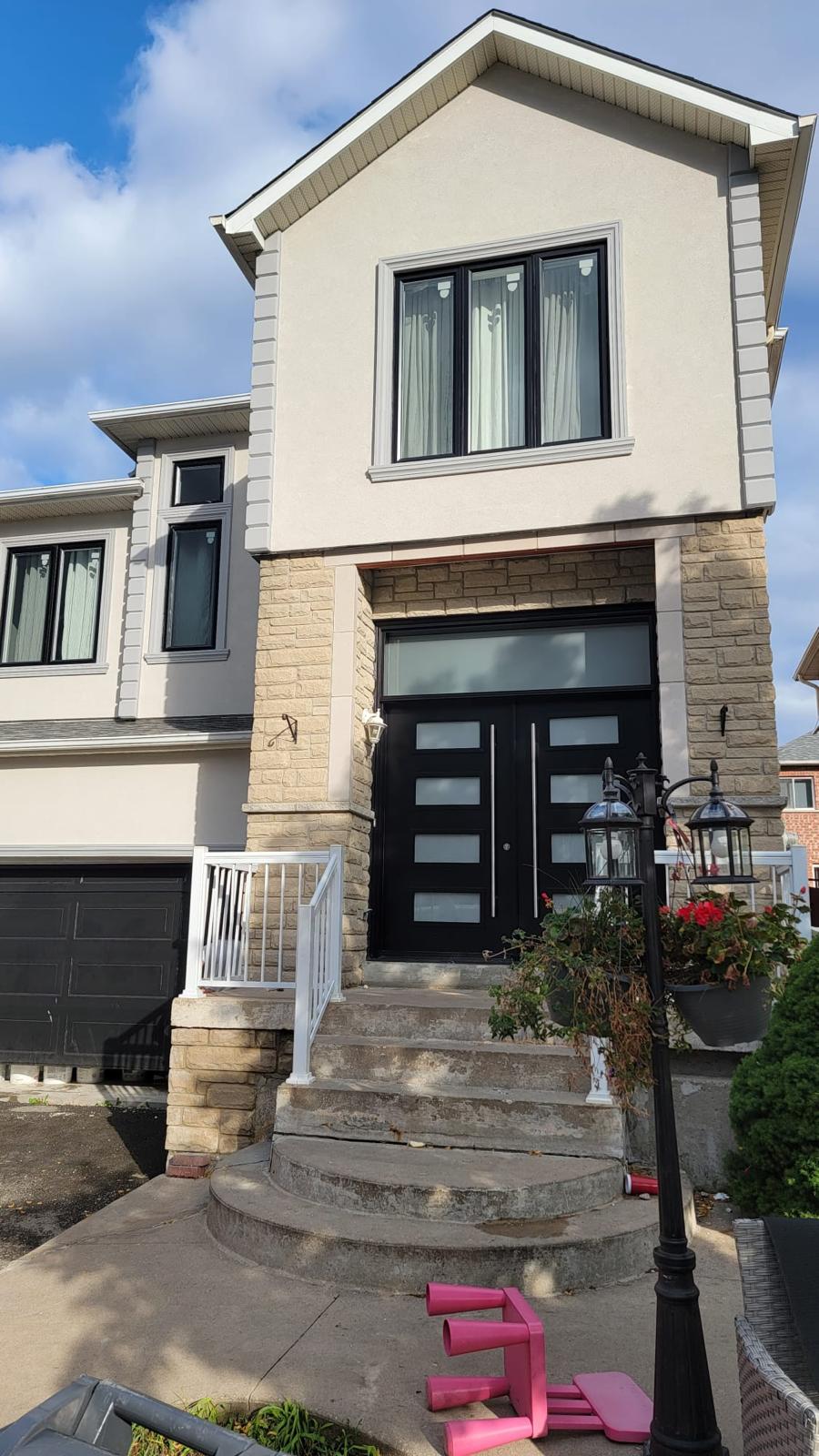 Black double-door entrance with stone surround