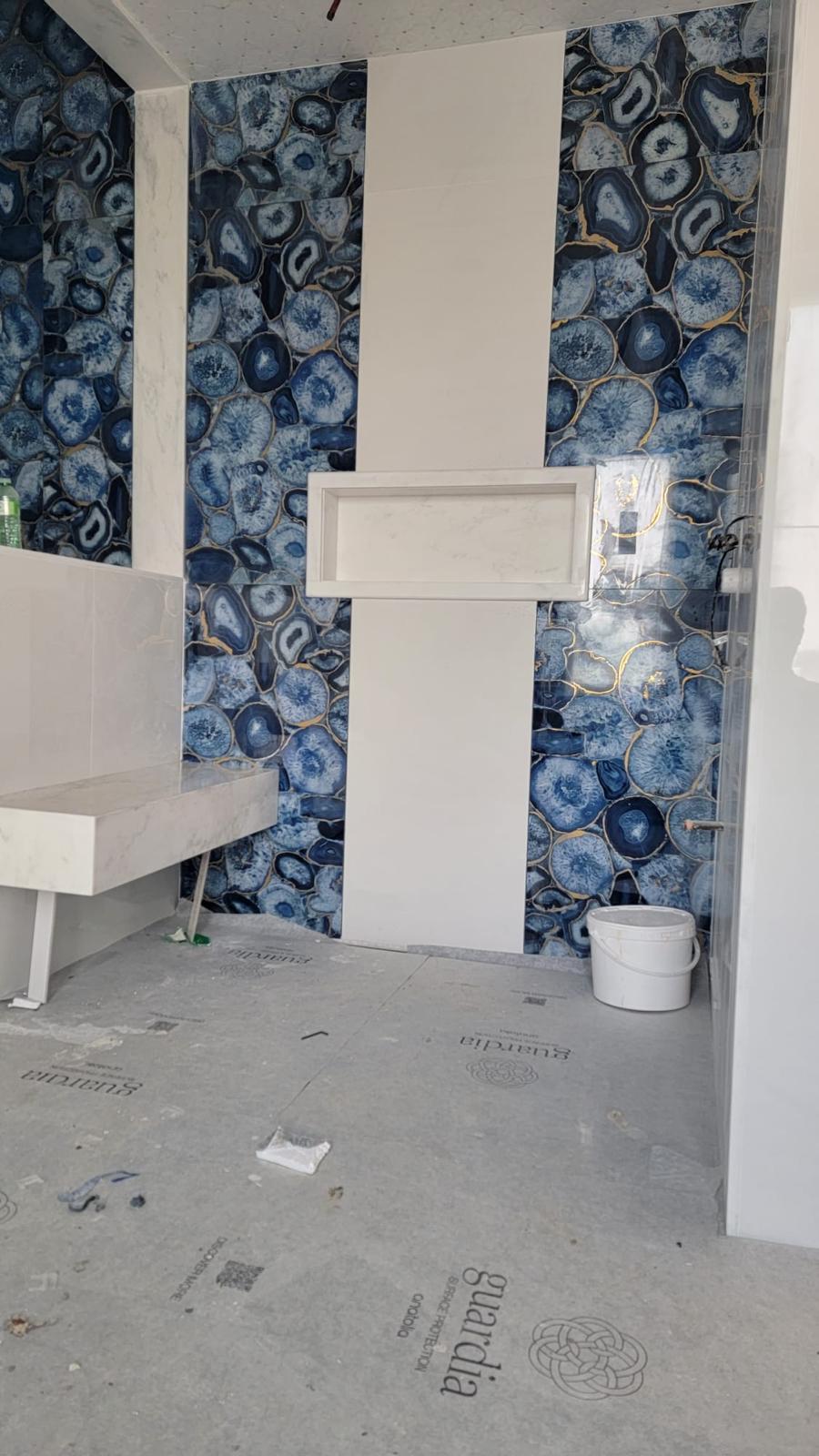 Luxury bathroom with blue and gold agate tile feature wall
