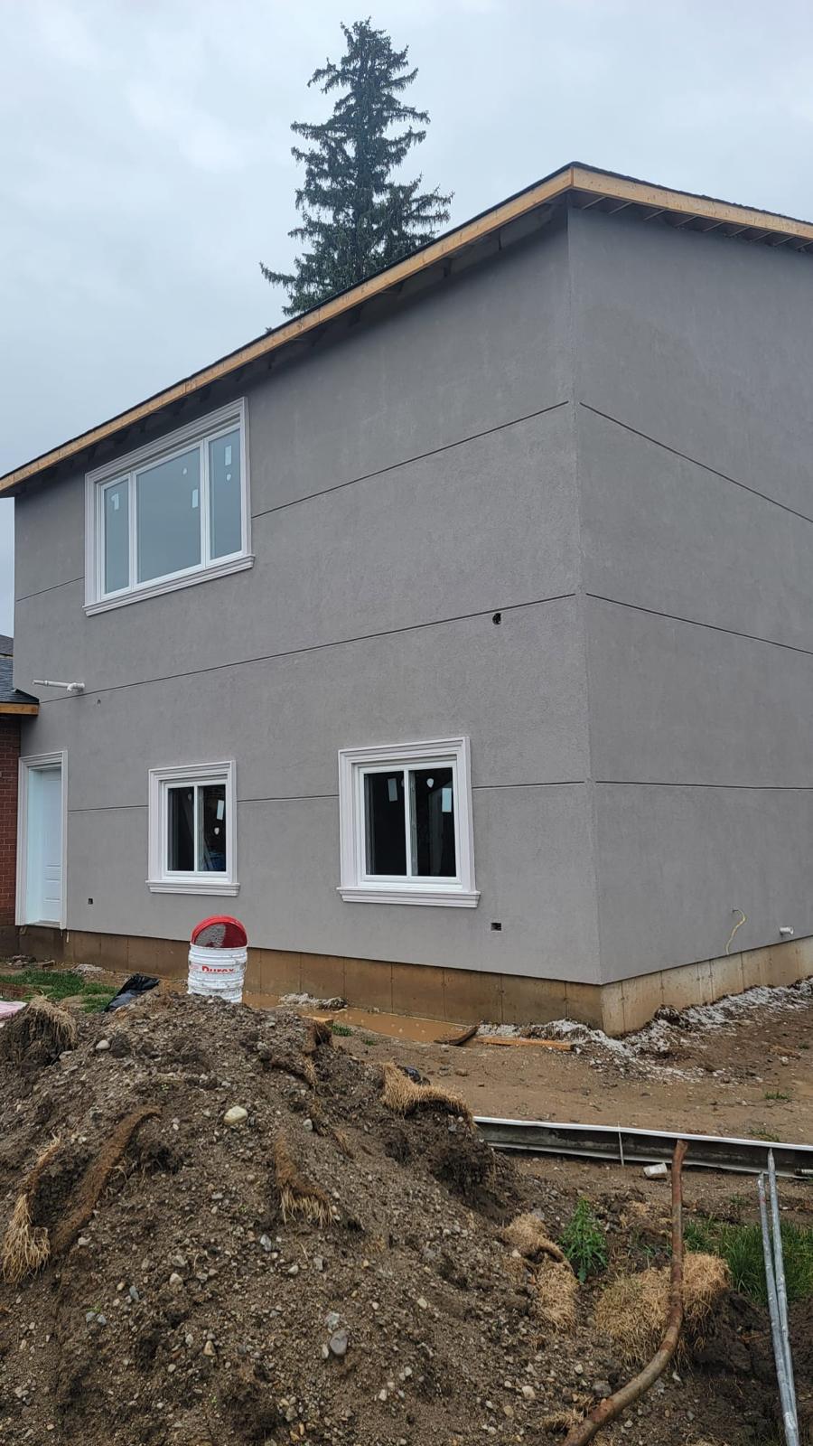 Grey stucco new build at foundation stage