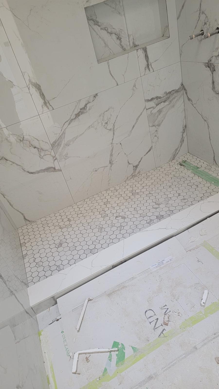 Marble shower bench with hexagon mosaic floor
