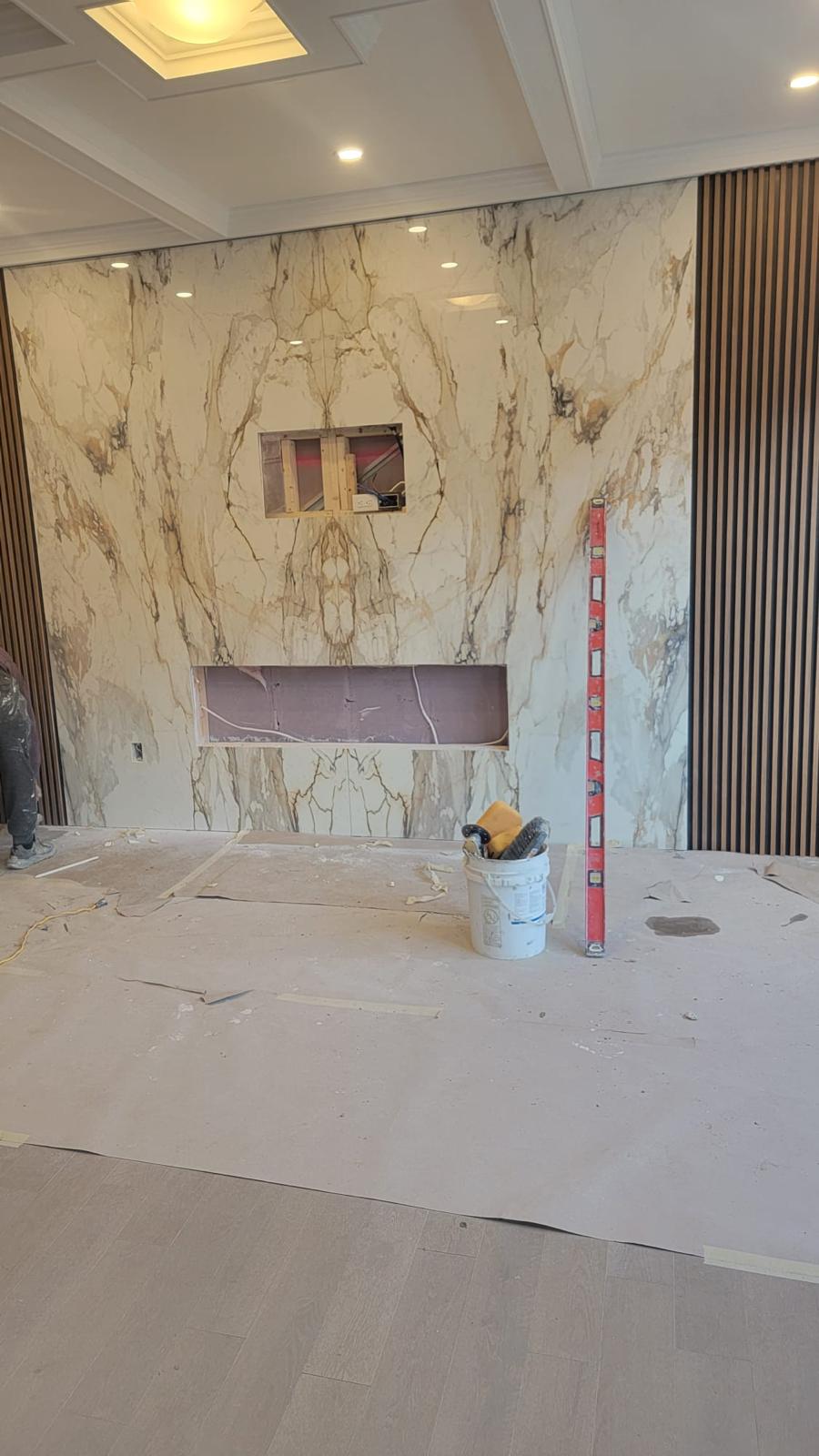 Book-matched marble feature wall with wood slat panels