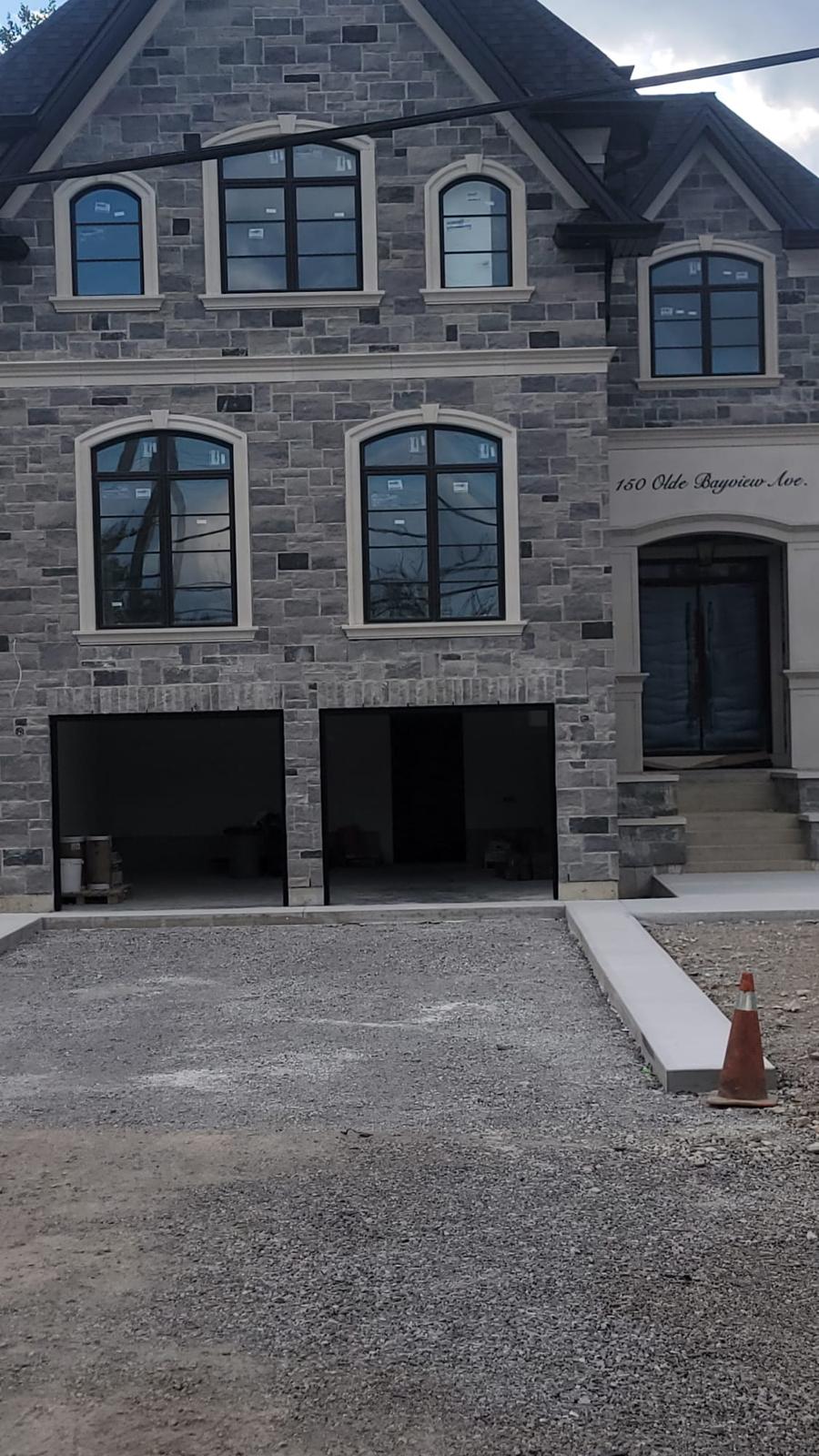 150 Olde Bayview Ave. stone-clad estate front elevation