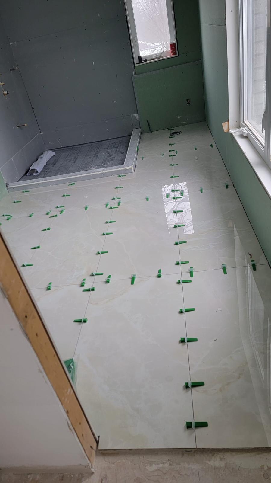 Warm-toned polished marble floor tile install